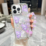 Custodia TPU con farfalla 3D glitterata e catena per iPhone 15 Pr