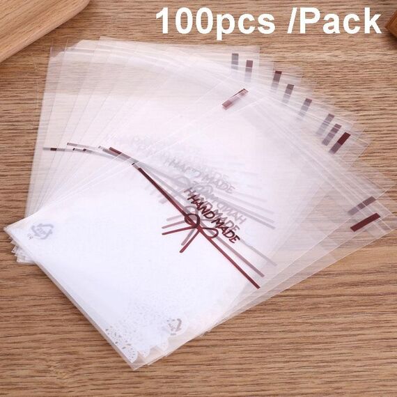 Confezione da 100 sacchetti autoadesivi per biscotti con fiocco in pizzo bianco 15x15 cm